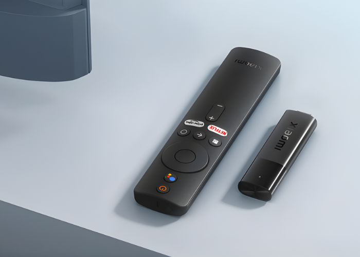 Xiaomi Mi TV Stick kompaktni uređaj položen na svijetlu podlogu, moderan dizajn za pametan TV